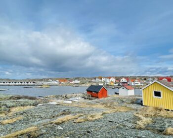 A view of red wooden houses on Vrango Archipelago island .